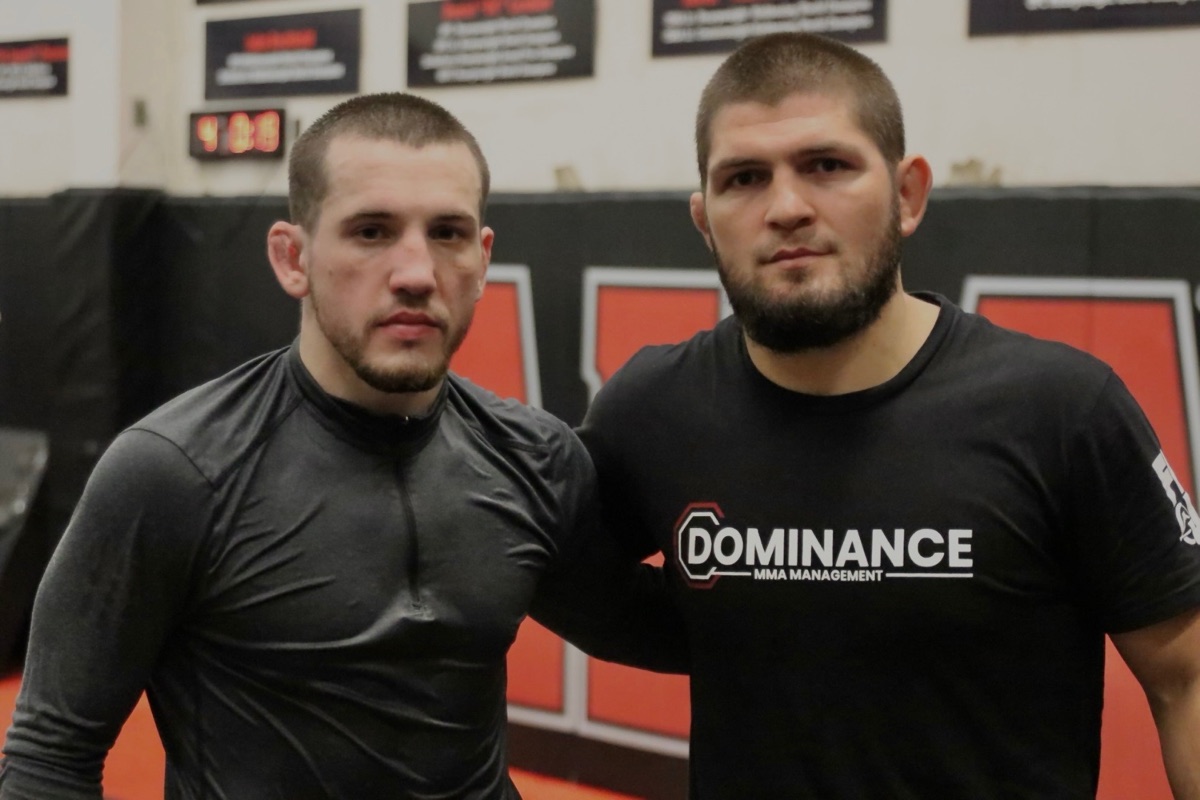 Coach David standing with Khabib Nurmagomedov