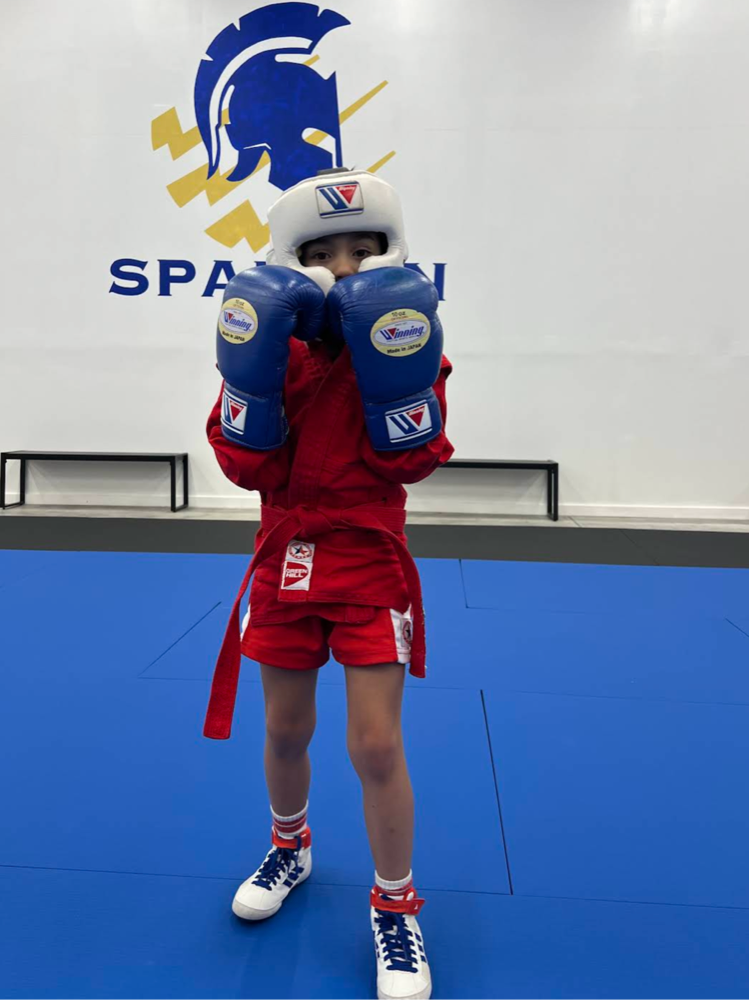 Young child in red Spartan kickboxing gear